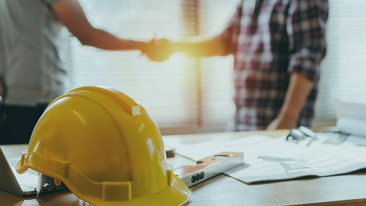 Two contractors shaking hands